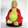 Statue de moine et son bol à obole en prière sous un mandala du Népal