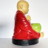 Statue de moine et son bol à obole en prière sous un mandala du Népal